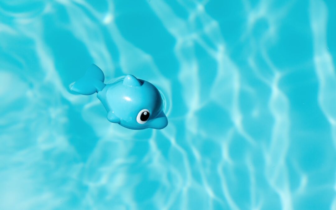 blue and white toy dolphin floating on water